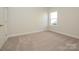 Bedroom featuring carpet flooring, a bright window, and neutral paint at 3111 Vermillion Dr, Harrisburg, NC 28075