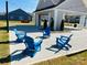 Inviting community area with blue Adirondack chairs beneath string lights for outdoor relaxation and socializing at 3111 Vermillion Dr, Harrisburg, NC 28075