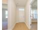Bright entryway featuring hardwood floors, a transom window, and views into adjacent rooms at 3111 Vermillion Dr, Harrisburg, NC 28075