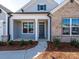 Close-up of the entrance to the home, showcasing a walkway, inviting porch, and manicured landscaping at 3111 Vermillion Dr, Harrisburg, NC 28075
