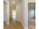 Hallway showcasing open doorways and hardwood floors at 3111 Vermillion Dr, Harrisburg, NC 28075