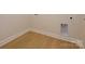 Laundry room with plank flooring, base molding, and utility connections at 3111 Vermillion Dr, Harrisburg, NC 28075