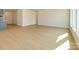 Bright living room features light wood flooring and ample natural light from large windows at 3111 Vermillion Dr, Harrisburg, NC 28075