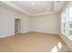 Large room with light wood floors, tray ceiling, recessed lights, and an en-suite bath at 3111 Vermillion Dr, Harrisburg, NC 28075