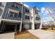 Three-unit townhome building with attached garages and landscaping at 3116 Butler Hill Dr, Matthews, NC 28105