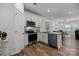 Open concept kitchen with island, stainless steel appliances, and view to living room at 3116 Butler Hill Dr, Matthews, NC 28105