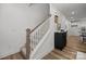 Modern staircase with wooden handrail and neutral color palette at 3116 Butler Hill Dr, Matthews, NC 28105