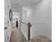 Upstairs hallway with carpeted floor and access to bedrooms at 3120 Butler Hill Dr, Matthews, NC 28105