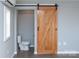 Clean bathroom with white vanity, toilet, and barn door at 320 Brown Rd, China Grove, NC 28023