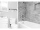 Modern bathroom with gray tile and a white bathtub at 320 Brown Rd, China Grove, NC 28023