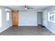 Bright living room with wood-look floors, sliding barn door, and ceiling fan at 320 Brown Rd, China Grove, NC 28023