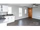 Open concept kitchen and living area with wood-look floors and white cabinets at 320 Brown Rd, China Grove, NC 28023