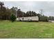 Tan mobile home with wooden steps and surrounding yard at 34&20 Shorty Miller Rd, Taylorsville, NC 28681