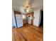 Simple kitchen with wood cabinets, white appliances, and wood floors at 34&20 Shorty Miller Rd, Taylorsville, NC 28681