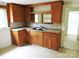 Kitchen featuring wood cabinets, a double sink, and tile floors at 374 Zion Church Rd, Mount Gilead, NC 27306