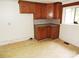 Galley kitchen with wood cabinets and tile flooring at 374 Zion Church Rd, Mount Gilead, NC 27306