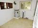 Small laundry room with water heater, shelving, and vinyl flooring at 374 Zion Church Rd, Mount Gilead, NC 27306