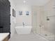 Spa-like bathroom with a large soaking tub, a walk-in shower, and modern fixtures at 3830 Mill Run, Terrell, NC 28682