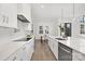 Modern kitchen featuring white cabinets, a large island, and hardwood floors at 3830 Mill Run, Terrell, NC 28682
