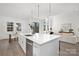 Open concept kitchen with white cabinets, a large island, and hardwood floors at 3830 Mill Run, Terrell, NC 28682