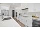 Modern kitchen with white cabinets, stainless steel appliances, and quartz countertops at 3830 Mill Run, Terrell, NC 28682