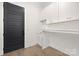 Laundry room with white cabinets, a countertop, and wood-look flooring at 3830 Mill Run, Terrell, NC 28682