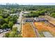 Aerial view of townhome development near retail area with a Charlotte city skyline in the background at 4121 Walking Ridge Rd # 54, Charlotte, NC 28208
