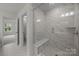Bathroom shower with built in bench and marbled tile surround at 4121 Walking Ridge Rd # 54, Charlotte, NC 28208