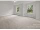 Bright bedroom featuring neutral carpet, recessed light and view from two windows at 4121 Walking Ridge Rd # 54, Charlotte, NC 28208