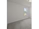 Clean and bright bedroom with carpet flooring and a window offering natural light at 4121 Walking Ridge Rd # 54, Charlotte, NC 28208