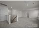 Bright bonus room with neutral carpet, recessed lighting and railing overlooking the stairs at 4121 Walking Ridge Rd # 54, Charlotte, NC 28208