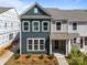 Charming new townhome with a stylish exterior, inviting covered entryway, and lush landscaping at 4121 Walking Ridge Rd # 54, Charlotte, NC 28208