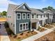 Beautiful new townhome with a modern exterior, landscaped yard, and inviting covered entrance at 4121 Walking Ridge Rd # 54, Charlotte, NC 28208