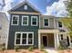 Charming two-story townhome featuring a welcoming front porch and a combination of vertical and horizontal siding at 4121 Walking Ridge Rd # 54, Charlotte, NC 28208