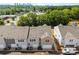 Aerial shows townhomes with gray siding and white garages, showcasing a modern aesthetic at 4121 Walking Ridge Rd # 54, Charlotte, NC 28208