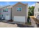 Two-car garage with modern gray siding in a new construction townhome community at 4121 Walking Ridge Rd # 54, Charlotte, NC 28208