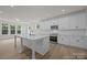 Modern kitchen boasts white cabinets, stainless steel appliances, and a large center island with bar seating at 4121 Walking Ridge Rd # 54, Charlotte, NC 28208