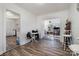 Open dining area with wood floors, table and chairs, and access to other rooms at 437 Brevard St, Statesville, NC 28677