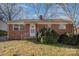 Brick ranch house with a yard and mature shrubs at 437 Brevard St, Statesville, NC 28677