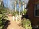 Backyard with wooden steps leading to wooded area at 5514 Grafton Pl, Charlotte, NC 28212