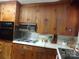 Classic kitchen with wood cabinets and built-in microwave at 5514 Grafton Pl, Charlotte, NC 28212