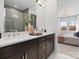 Bathroom featuring a double sink vanity, large mirror, and glass-enclosed shower at 5608 Kingspan Dr, Charlotte, NC 28217