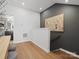 Upstairs hallway featuring hardwood floors and neutral paint, leading to additional rooms at 5608 Kingspan Dr, Charlotte, NC 28217