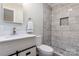 Bathroom featuring white vanity, marble tiled shower with a built-in shelf and penny tile floor at 6726 Lockhart Rd, Sharon, SC 29742