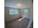 Bright bedroom with neutral walls, laminate flooring, and lots of natural light from three large windows at 6726 Lockhart Rd, Sharon, SC 29742