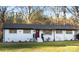 White ranch house with black roof, red door, and landscaped yard at 6726 Lockhart Rd, Sharon, SC 29742