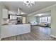 Open-concept kitchen and living room area with stainless steel appliances and matching laminate floors at 6726 Lockhart Rd, Sharon, SC 29742