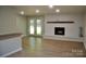 Living room with a decorative fireplace, white brick wall, French doors, and laminate flooring at 6726 Lockhart Rd, Sharon, SC 29742