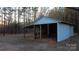 Small white outbuilding with a covered area and wooden posts at 6726 Lockhart Rd, Sharon, SC 29742