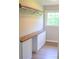 Walk-in closet featuring laminate floors, long wooden top, lots of cabinet space, and a metal hanging rod at 6726 Lockhart Rd, Sharon, SC 29742